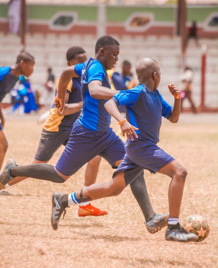 Footballer driving the ball forward