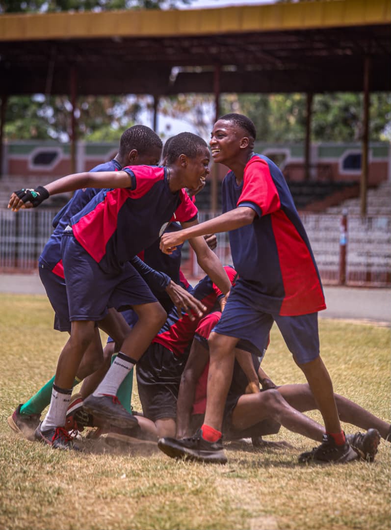 Team celebrating a goal in a pile