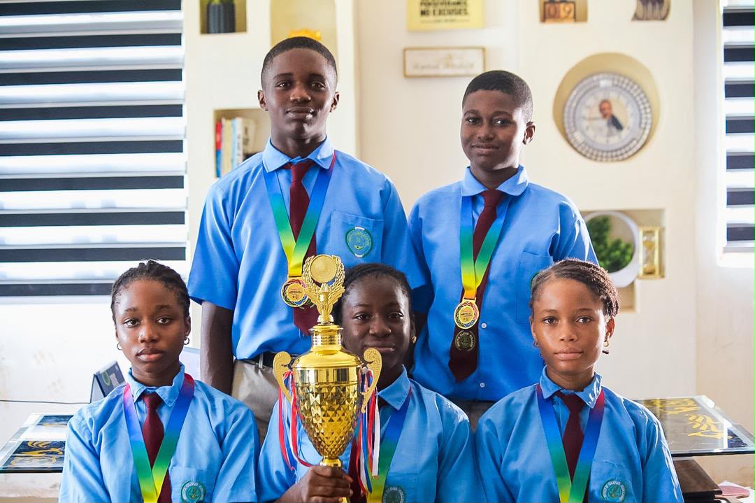 Students with the championship trophy and their medals